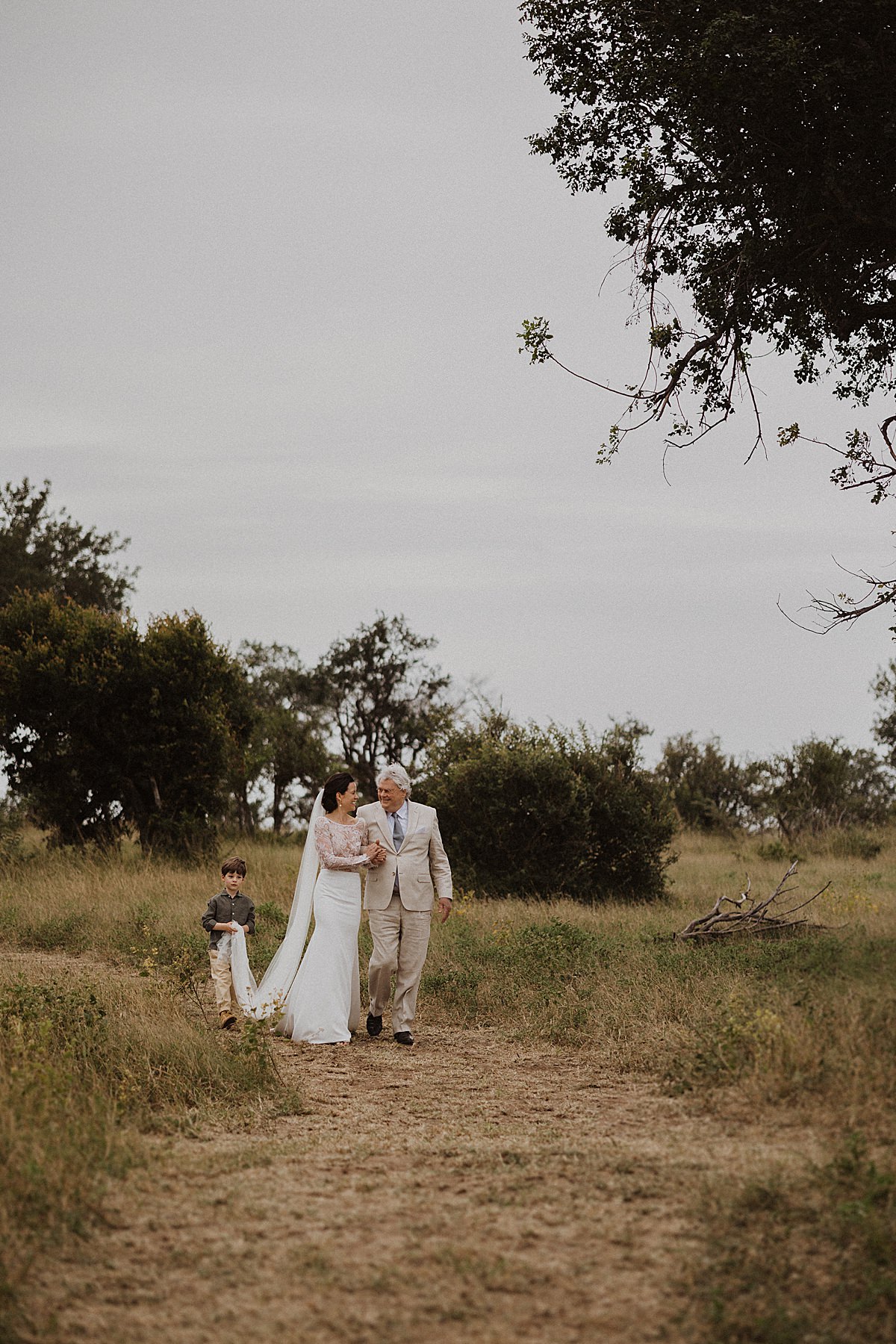Hoedspruit Wedding Photographer. Father and daughter and son walk down the isle.