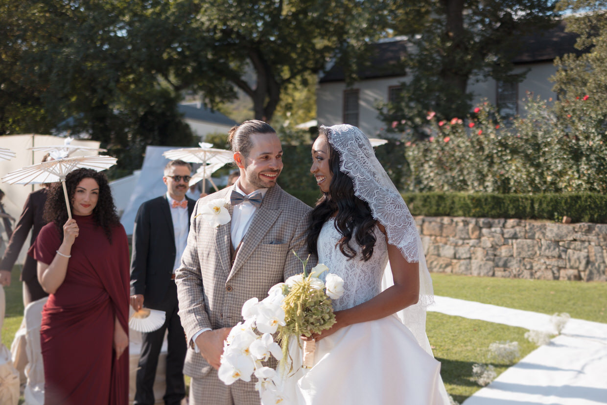 bride and groom smiling at each other during the wedding ceremony